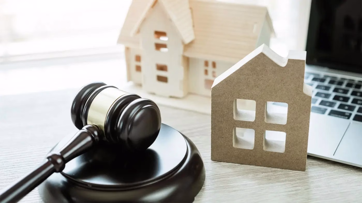 How Legal Troubles Impact Homeownership in North Carolina House with a gavel symbolizing legal issues affecting homeownership in North Carolina