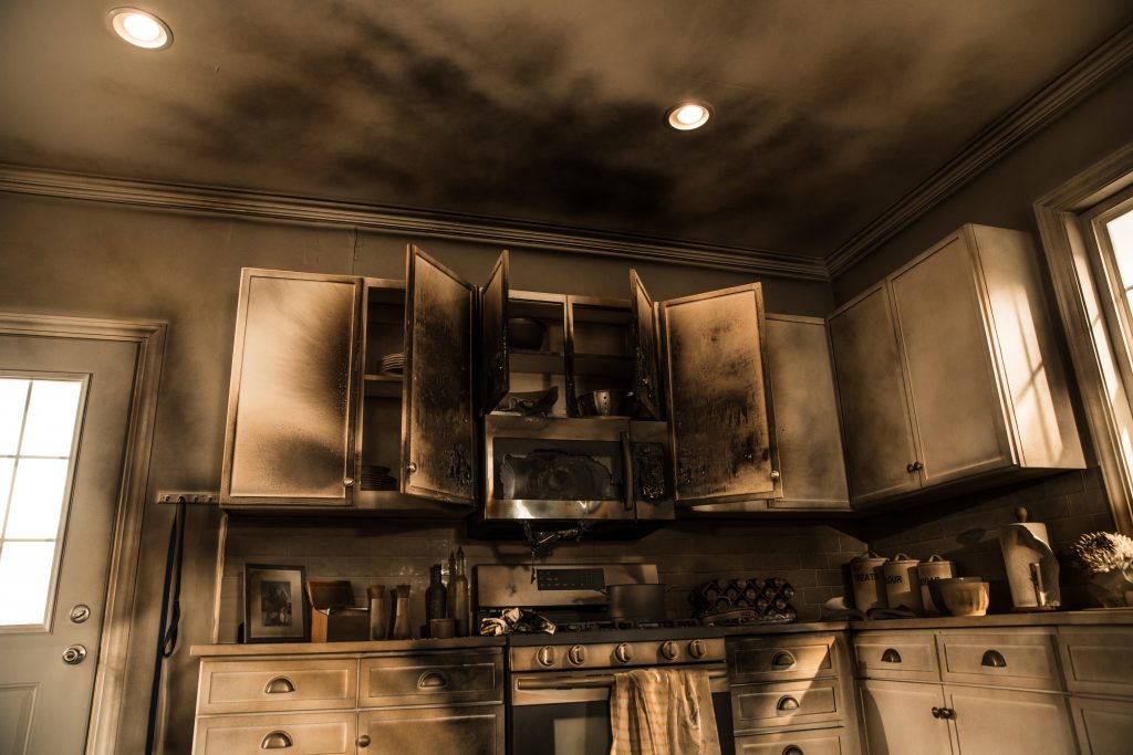 A fire-damaged kitchen with blackened cabinets, representing selling a Gastonia home as-is for cash.