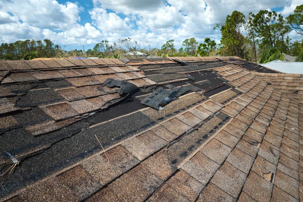 A house in High Point with visible roof damage, symbolizing the need for quick repairs or a cash sale.