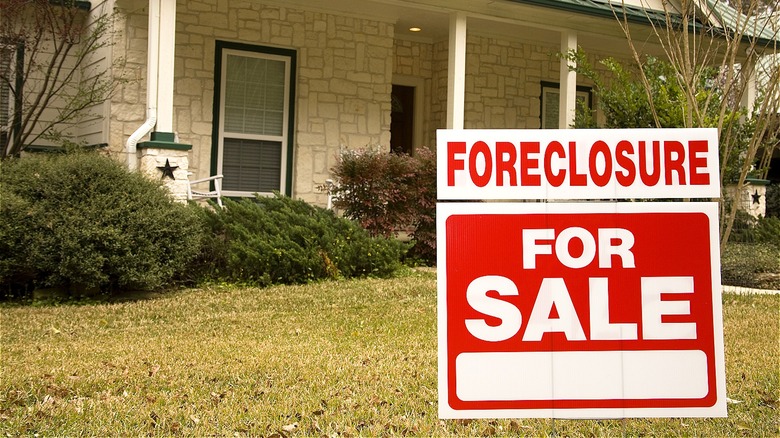 A house with "Foreclosure" and "For Sale" signs in Kernersville, NC.